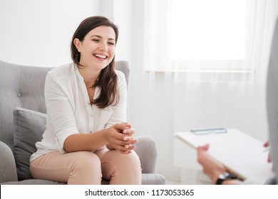 Happy young woman talking to a financial expert about a loan for a new apartment