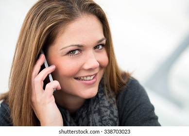 happy young woman talking on the phone smiling