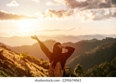 Happy young woman traveler relaxing and looking at the beautiful sunrise on the top of mountains, Travel lifestyle concept - Powered by Shutterstock