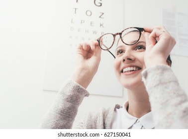 Happy Young Woman Trying Her New Glasses, Eye Care Concept