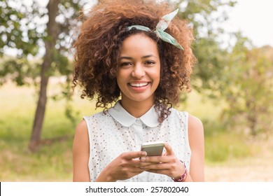 Happy Young Woman Using Smartphone On A Sunny Day