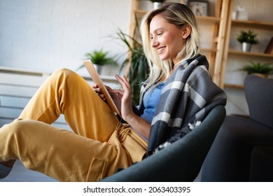 Happy Young Woman Using Tablet Pc In Loft Apartment