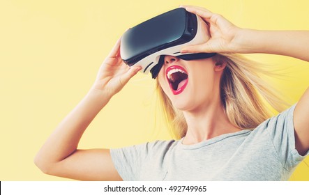 Happy young woman using a virtual reality headset