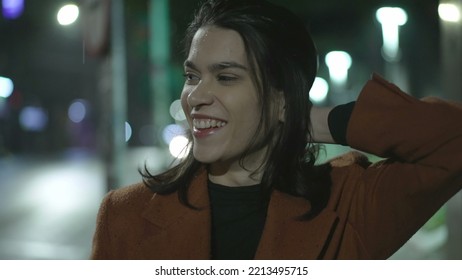 Happy Young Woman Walking In Rain At Night In City Street. Carefree Millennial Businesswoman Walks In Sidewalk In The Evening After Work In Drizzle Alone