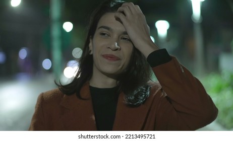 Happy Young Woman Walking In Rain At Night In City Street. Carefree Millennial Businesswoman Walks In Sidewalk In The Evening After Work In Drizzle Alone