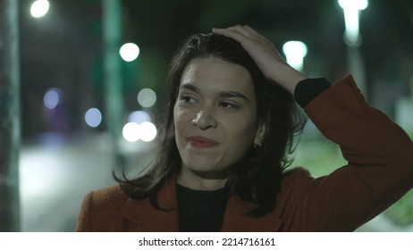 Happy Young Woman Walking In Rain At Night In City Street. Carefree Millennial Businesswoman Walks In Sidewalk In The Evening After Work In Drizzle Alone