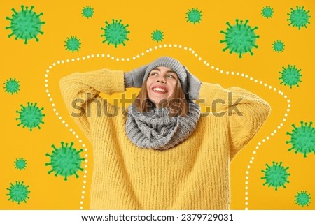 Happy young woman in warm clothes and virus on yellow background. Concept of strong immunity