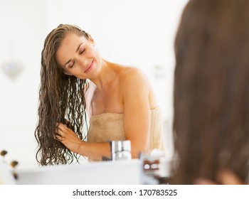 Happy Young Woman With Wet Hair In Bathroom