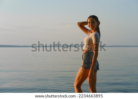 Similar – Young woman standing with closed eyes at the Baltic Sea beach