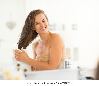 Happy Young Woman Wiping Hair With Towel