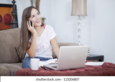 Happy young woman working from home and talking to a customer