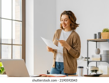 Happy young woman working, watching webinar, podcast on laptop, having remote conversation. - Shutterstock ID 2190592043