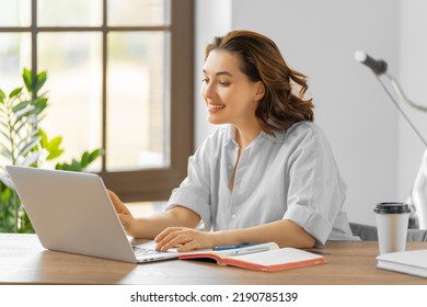 Happy young woman working, watching webinar, podcast on laptop, having remote conversation. - Shutterstock ID 2190785139