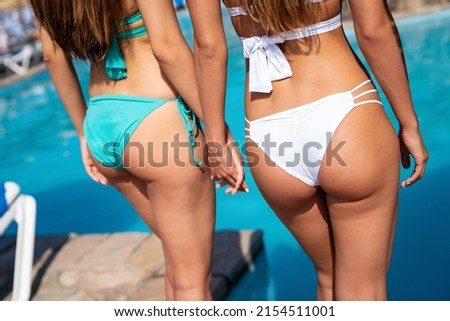 Happy young women friends enjoying summer vacation on the beach. People travel holiday fun concept