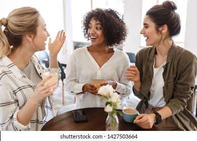Happy young women friends having coffee break while relaxing at the cafe indoors - Shutterstock ID 1427503664