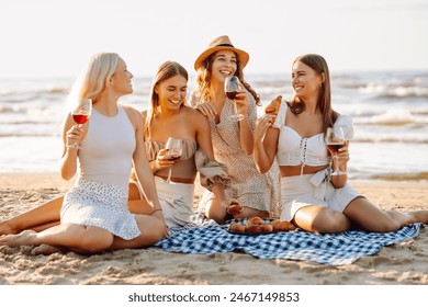 Happy young women posing with wine glasses having fun on the beach, celebrating hen party at coastline and enjoying their vacation. - Powered by Shutterstock