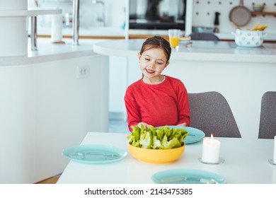 Happylittle Girl Setting The Table For Family Lunch During Holidays. Girl Setting Table. Preschooler Kid Helping Mother To Set Table In Kitchen.