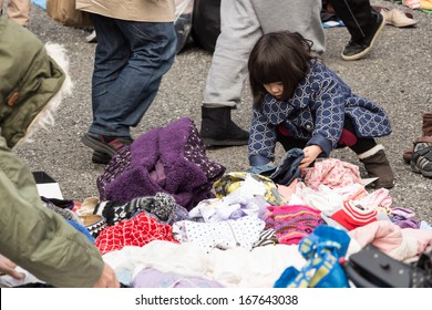 Harajuku, Japan - December 8: Unidentified Kid Choose The Second Hand Clothes At Flea Market In Yoyogi Park, Harajuku On December 8, 2013.