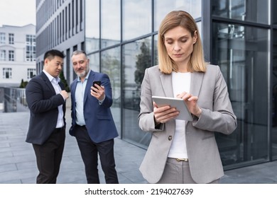 Harassment And Stalking Bullying In The Office, Business People Colleagues Men Making Fun Of A Woman, Business Team Standing Outside The Office Building Gossiping About The Boss's Woman Men