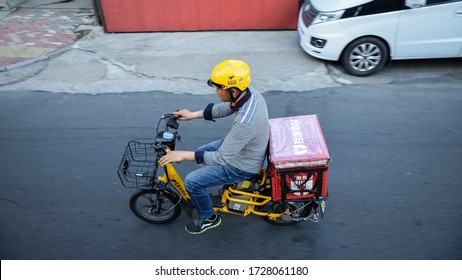 Harbin, China - June 23, 2019: Food Delivery Man Driving Electric Scooter On The Road. Selective Focus.