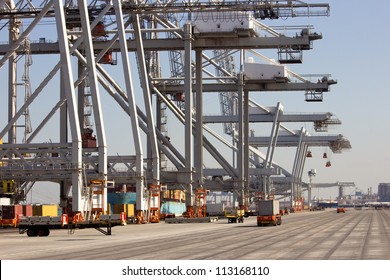 Harbor Container Cranes And Robot Trucks.