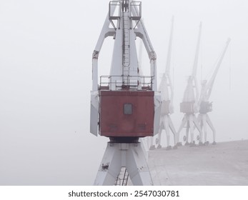 Harbor cranes in a foggy morning. - Powered by Shutterstock