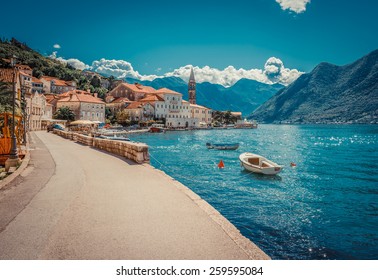 Harbour and boats in sunny day at Boka Kotor bay (Boka Kotorska), Montenegro, Europe. Retro toned image. - Shutterstock ID 259595084