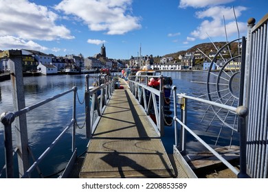 The Harbour At East Loch Tarbert With A Gang Way Leading To Moored Fishing Craft. East Loch Tarbert, Argyll And Bute. Scotland