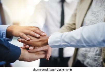 Its Hard To Beat Someone Who Wont Give Up. Cropped Shot Of A Group Of Businesspeople Putting Their Hands Together In Unity.