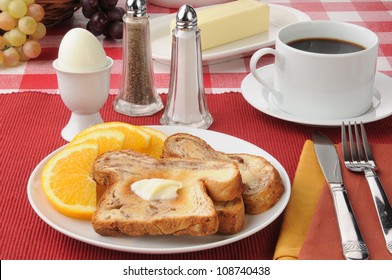 A Hard Boiled Egg With Cinnamon Toast And Coffee