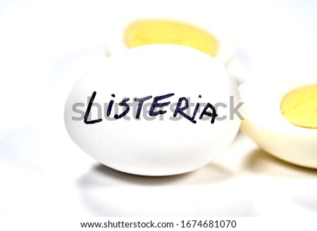 Hard boiled egg with Listeria writing on egg. Listeriosis is a food-borne infection caused by Listeria bacteria. Listeria is caused by bacteria that can grow at cold temperatures