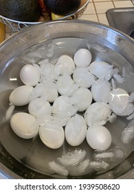 Hard boiled eggs cooling off in an ice bath.