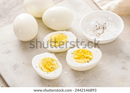Hard boiled eggs peeled and cut in half with salt and pepper