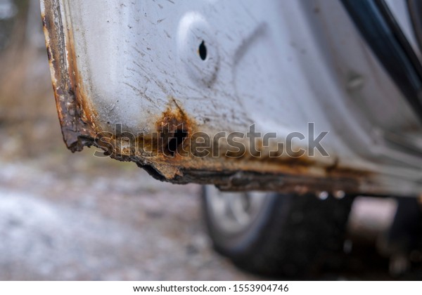 Hard corrosion and rust on the body and doors of\
the car white