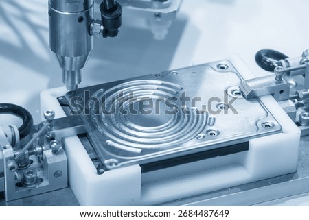 The hard disk assembly process by automatic screw driver in the blue tone scene. The hard drive mass production by robotic system. 