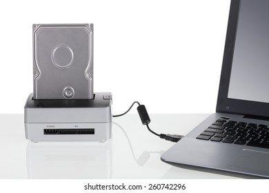 Hard Disk Drive With Docking Station Connected To A Laptop Computer. For Data Storage.