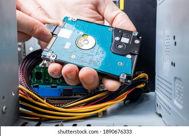 hard disk drive or hdd close up view. technician installing hdd to a desktop pc. inside view. pc repair service concept.