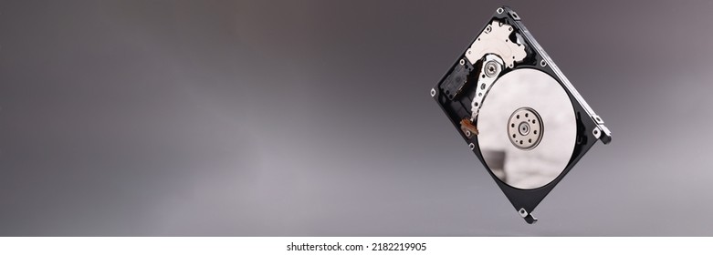 Hard disk drive HDD with open top cover on gray background