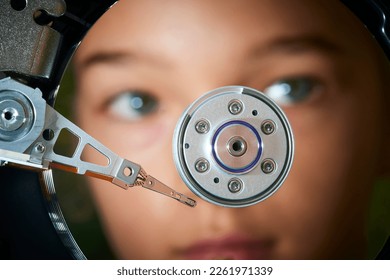 Hard disk drive inside. Data safety concept. Reflection of the child girl face as in a mirror. Artificial inteligence