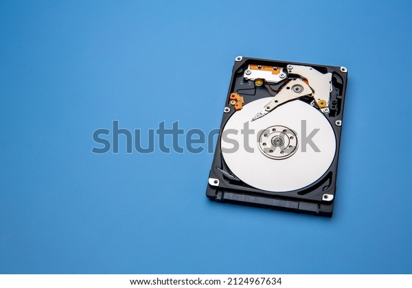 Hard disk drive and open\
cover. Computer hardware, hard disk, storage device. Detail of the\
inside of a hard disk drive. Hard disk is internal mechanism\
hardware