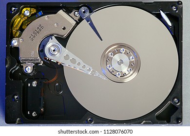 Hard disk drive platter. Open hdd hard disk. Data recovery from damaged media. Disk head above the plates