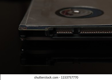 Hard disk for laptop storage data on black black background with reflection. New technology is ahead of us.