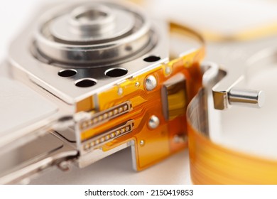 Hard Drive Detail With Shiny Metal Parts And Orange Tape On Light Background Macro