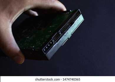 hard drive in hand, solid state hdd drive on a dark background closeup