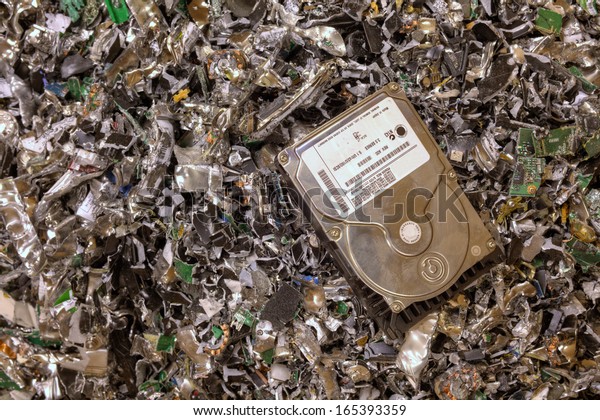 A\
hard drive resting on a pile of shredded hard\
drives