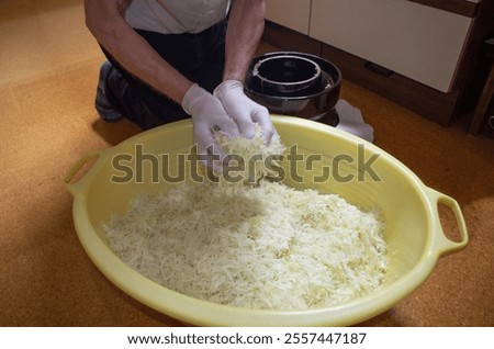 Hard, laborious manual work with raw white cabbage.