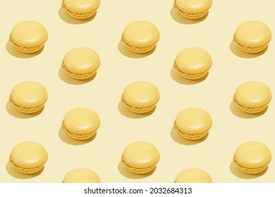 Hard Light Pattern Of A Yellow Macaron Pastry On Bright Yellow Background