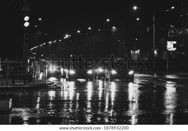 Hard rain fall at night with blurry cars.\
Selective focus.
