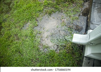 Hard rainwater pouring out of getters and a drain spout after a day of heavy rains and storms
