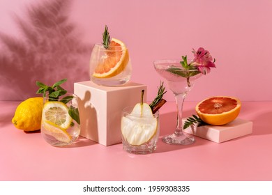 Hard Seltzer Cocktails With Various Fruits: Pear, Grapefruit, Lemon. Refreshing Colorful Summer Drinks On Pink Background With Shadow Fern. 